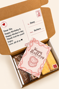 Gift box with a card and a small gift on a white background